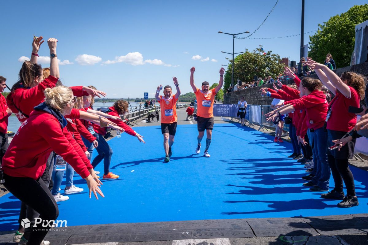 Arrivée de coureurs encouragés par les bénévoles du Marathon de la Loire